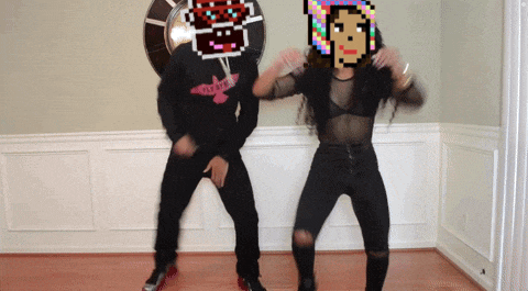 a man and a woman are dancing in a room with a pixelated image of a woman behind them that says playboy