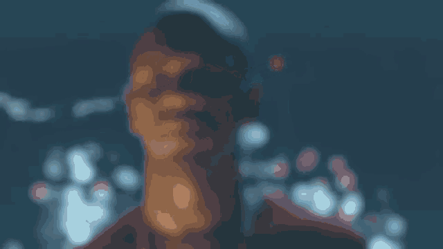 a blurry picture of a man 's face against a dark background