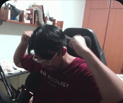 a man wearing glasses and a shirt that says nus sciology