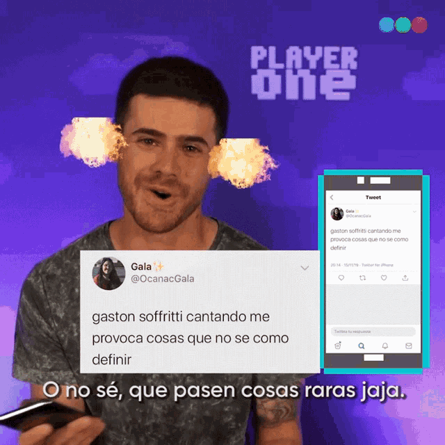 a man is holding a cell phone in front of a player one tweet