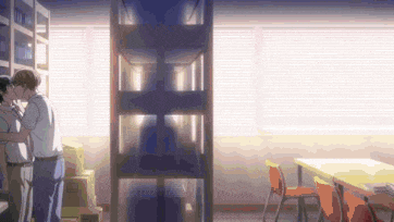 a couple of men are kissing in a room with a bookshelf in the background .