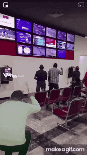 a man sitting in front of a wall of monitors that says spin on it