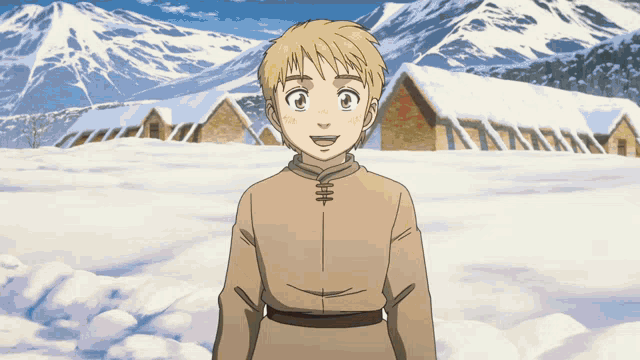 a young boy stands in front of snow covered buildings