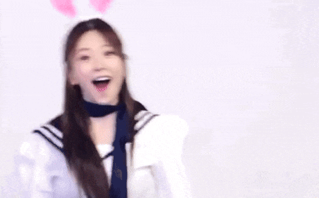 a young woman wearing bunny ears and a choker is making a surprised face .