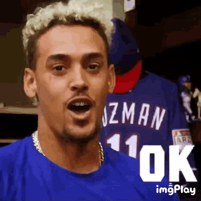 a man wearing a blue shirt with a number 11 on it