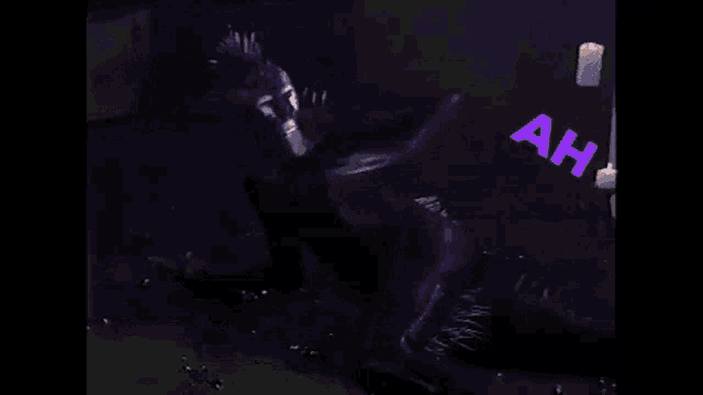 a person in a black bodysuit is laying on the ground in the dark with the words the light written on the wall behind them .