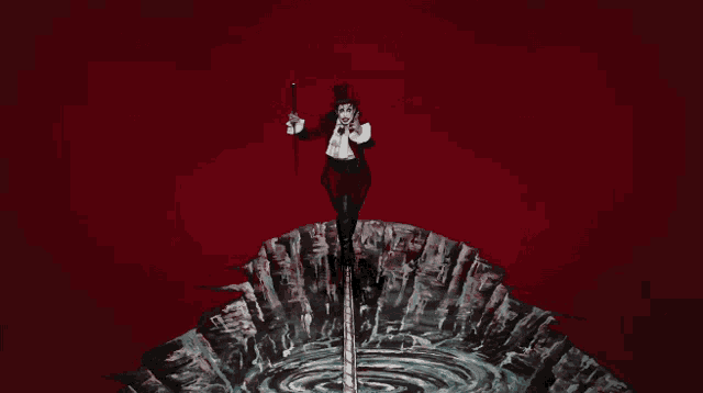 a man in a top hat is holding a cane and standing on a cliff