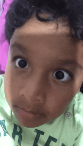 a close up of a child 's face wearing a shirt that says rte