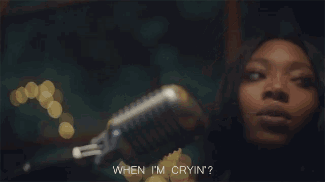 a woman singing into a microphone with the words when i 'm cryin ' written below her