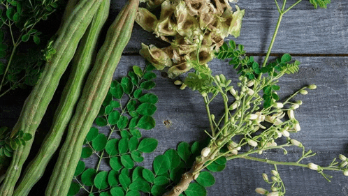 a bunch of green vegetables on a wooden surface