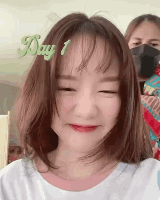 a girl with her eyes closed is wearing a mask and smiling with the words day 1 written above her head .