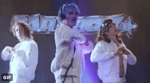 a group of men are dancing on a stage in front of a sign that says ' a ' on it .