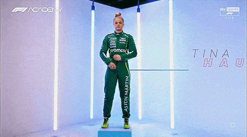 a woman in a green racing suit with the name tina hausmann on it