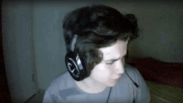 a man wearing a pair of headphones with the letter s on it