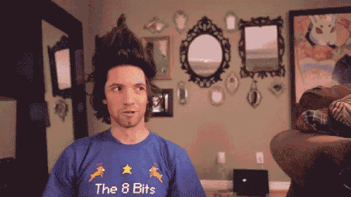 a man wearing a blue shirt that says the 8 bits on it