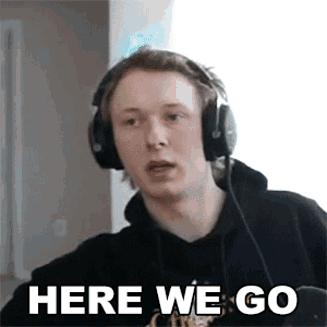 a young man wearing headphones is making a funny face and says `` here we go '' .