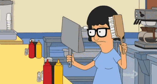 bob 's burgers bob brushes his hair with a brush in a kitchen