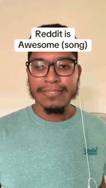a man wearing glasses and a t-shirt that says ' reddit is awesome ( song ) ' on it