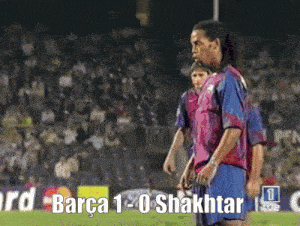 a soccer player stands on a field with the words barça 1-0 shakhtar written on the bottom