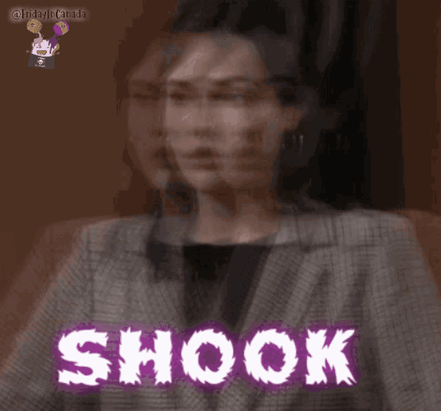 a woman in a plaid jacket with the word shook on her chest