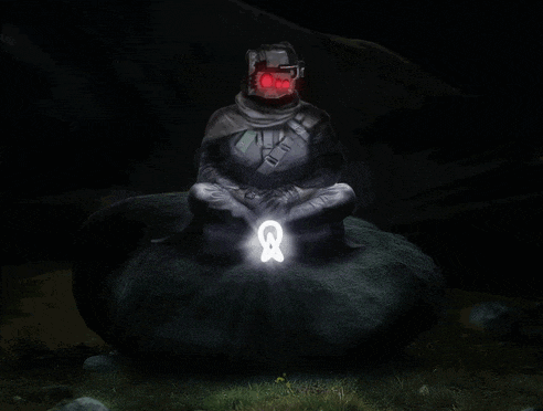 a man sitting on a rock with a light coming out of his hand