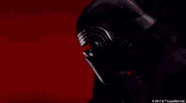 kylo ren from star wars is wearing a black helmet and a black jacket .