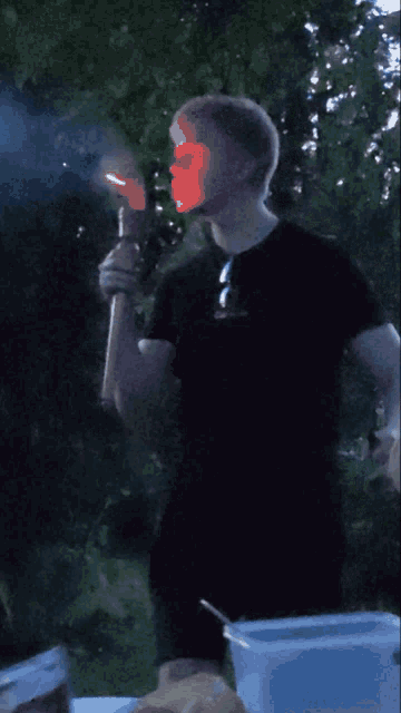 a man holding a torch with a red light coming out of it
