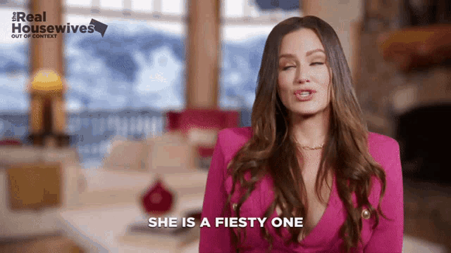 a woman says she is a fiesty one in front of a real housewives logo