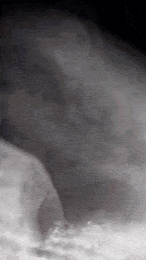 a blurred image of a person in a dark room