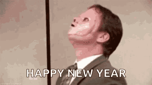 a man in a suit and tie is wearing a mask and looking up at the sky .