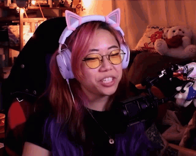 a woman wearing a headband with cat ears and yellow lenses