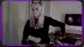 a woman wearing cat ears and a black shirt is standing in front of a tv