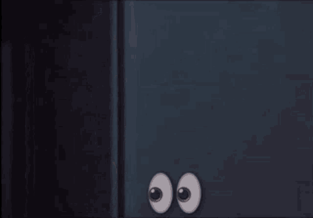 a woman is peeking out from behind a wall with cartoon eyes on it .