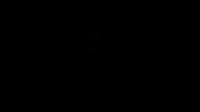 a woman wearing glasses and a brown shirt is walking in the dark