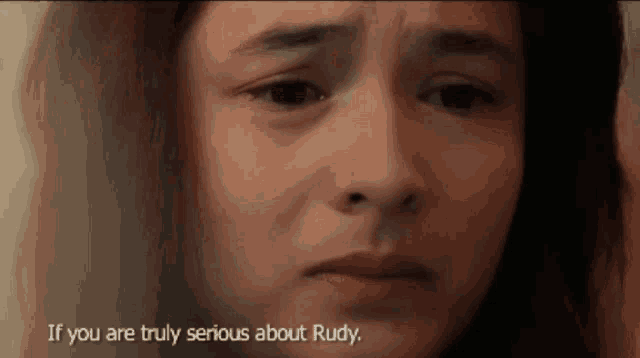 a close up of a girl 's face with the words if you are truly serious about rudy below her