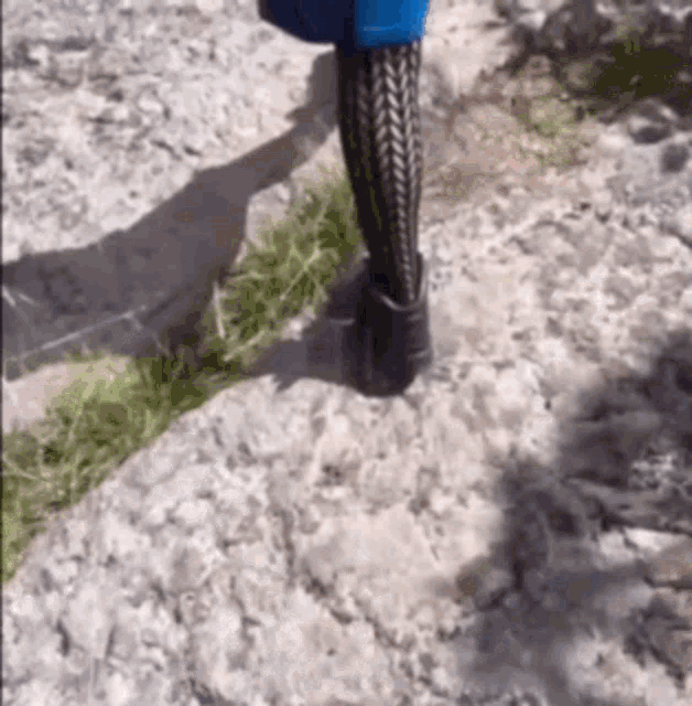 a person walking on a rocky path wearing tights