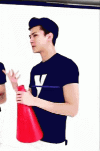 a man wearing a black shirt with the letter v on it