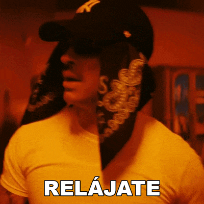 a man wearing sunglasses and a bandana has the word relajate written on his shirt