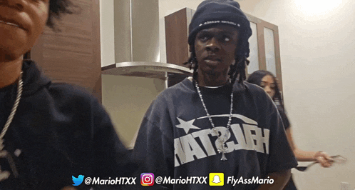 a man wearing a hat and a shirt that says " nat2jah "