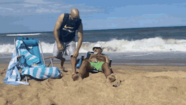 a man in a nike shirt is standing next to a man in a beach chair