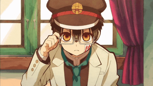 a boy wearing a hat and glasses has a bandage on his forehead