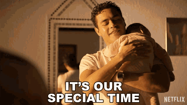a man holding a baby with the words " it 's our special time " below him