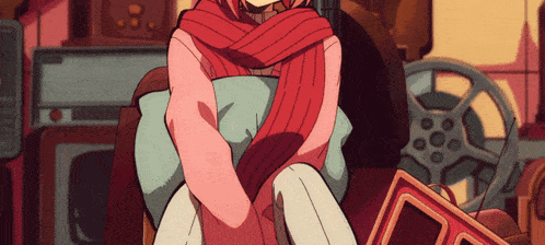 a girl with a red scarf around her neck sits in a chair