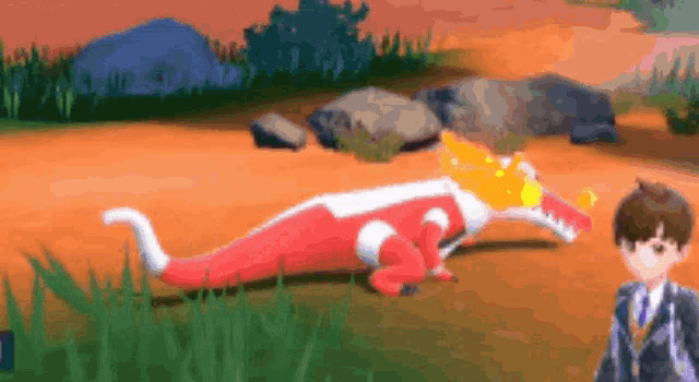 a boy in a suit is standing next to a red and white dinosaur .