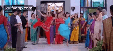 a group of people are dancing in a room in front of a crowd .