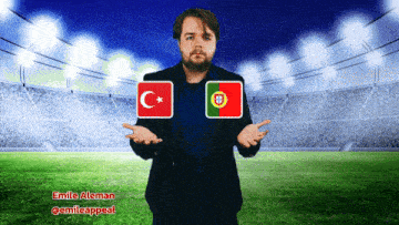 a man in a suit stands in front of a soccer field with a turkey and portugal flag
