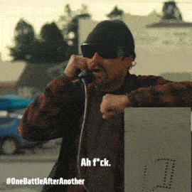 a man wearing sunglasses and a beanie is talking on a phone with the words ah f * ck above him