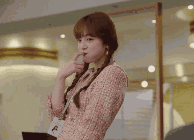 a woman wearing a lanyard with a name tag that says a on it