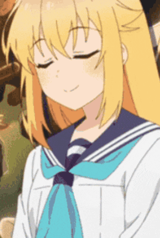 a girl with blonde hair and a blue tie is wearing a sailor uniform .
