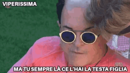 a man wearing sunglasses and a pink shirt says viperissima ma tu sempre lace l' hai la testa figlia